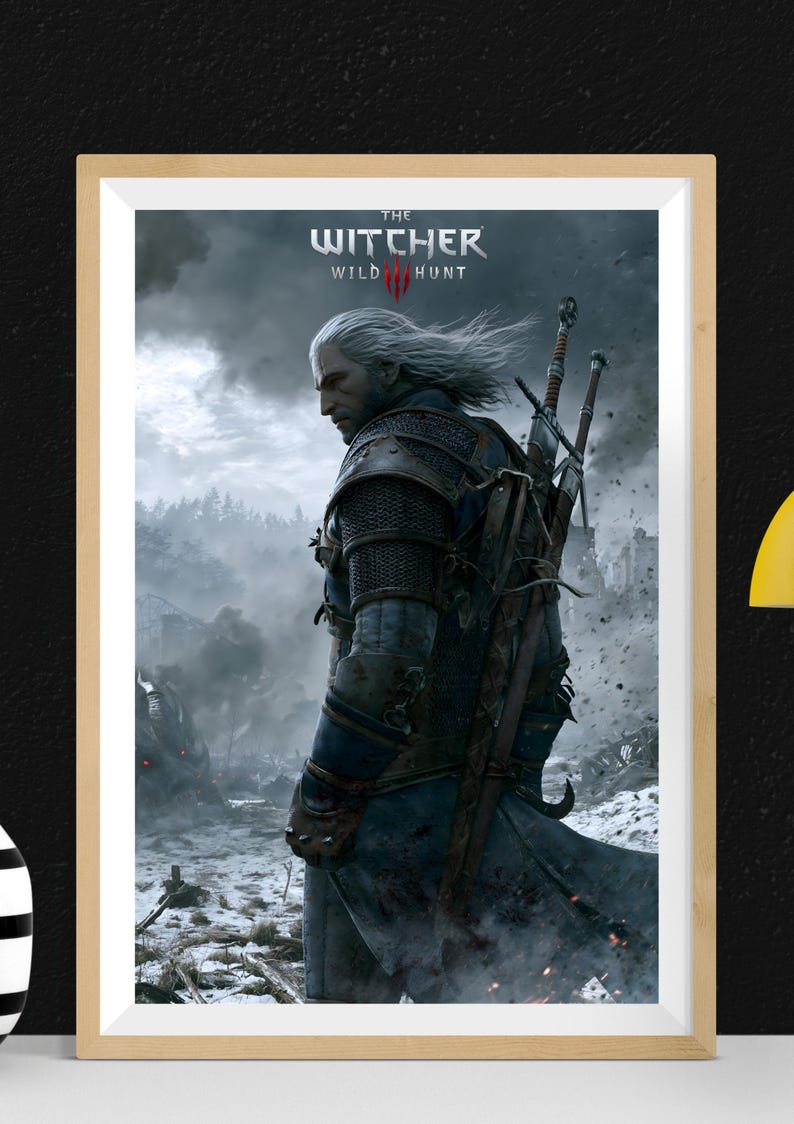 Peut inclure: Impression encadr&eacute;e du jeu vid&eacute;o "The Witcher 3: Wild Hunt". L'&oelig;uvre repr&eacute;sente un homme aux cheveux blancs et en armure, portant des &eacute;p&eacute;es, sur fond de paysage montagneux enneig&eacute;. Le logo du jeu est en haut.