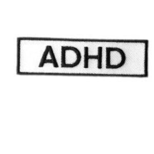Puede incluir: Parche rectangular blanco con borde negro y el texto "ADHD" en negro.