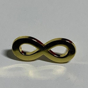 May include: A gold infinity symbol charm.