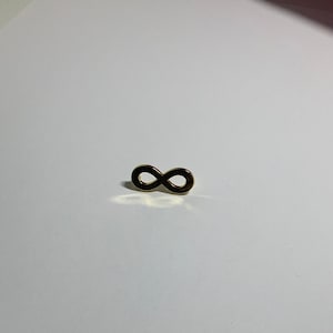 May include: A gold infinity symbol charm pendant.