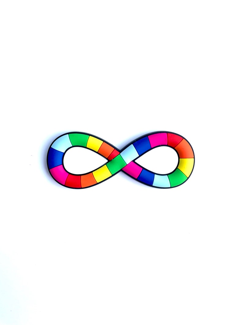 May include: A colorful infinity symbol with a rainbow pattern. The symbol is composed of various rectangular segments in shades of red, orange, yellow, green, blue, and purple, outlined in black. The object is set against a white background.