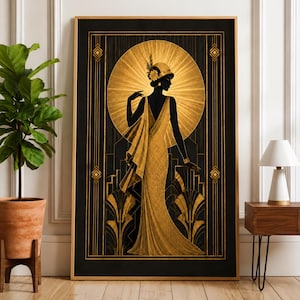 May include: A rectangular framed wall art print featuring a black silhouette of a figure in a long, flowing gold gown and a cloche hat. The background displays a radiant gold sunburst pattern and geometric architectural motifs in black and gold.