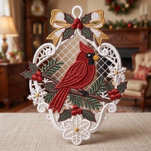 May include: A white lace ornament featuring a red cardinal bird perched on a branch with green pine needles and red holly berries. The design includes a gold-trimmed bow at the top, white snowflake accents, and a decorative lattice frame.