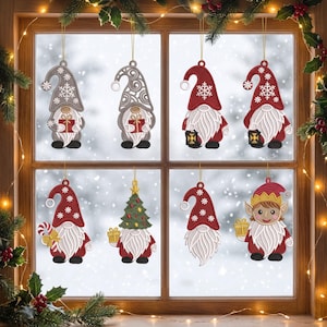 May include: Eight hanging ornaments featuring gnome figures in red and grey colour schemes. The designs include gnomes holding gifts, lanterns, or candy canes, some wearing hats with snowflake or swirl patterns, and one gnome wearing an elf hat.