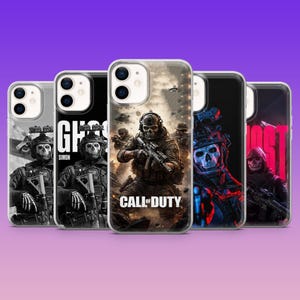 May include: A collection of five phone cases featuring action-themed graphics. The cases display images of soldiers, skulls, and the "Call of Duty" logo. The cases are in a row against a purple gradient background.