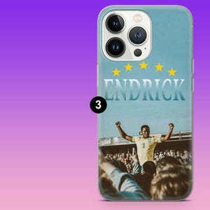 May include: A light blue smartphone case featuring a graphic of a soccer player in a yellow jersey with the number 9, arms raised in celebration before a crowd. The name ENDRICK is printed in white above the player, with five yellow stars.