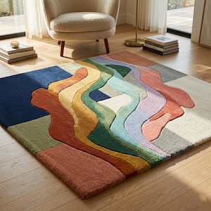 May include: A rectangular area rug featuring a multi-coloured abstract design with wavy, layered shapes in shades of navy blue, mustard yellow, terracotta, sage green, light blue, lavender, and cream, with a high-pile, textured surface finish.