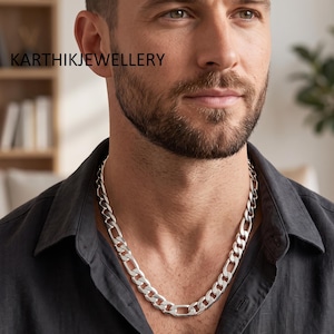 May include: A thick, polished silver-tone figaro chain necklace featuring a repeating pattern of three small circular links followed by one elongated oval link. The text KARTHIKJEWELLERY is visible in the upper left corner of the image.
