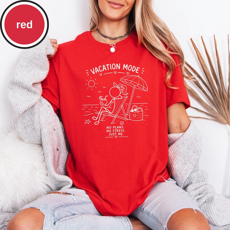 May include: A red t-shirt with a white graphic of a person relaxing on a beach chair under an umbrella. The text "VACATION MODE" and "NO PLANS. NO STRESS. JUST ME." are also printed on the shirt.