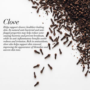 May include: A top-down shot of whole cloves scattered on a white surface. The image includes the word "Clove" in a stylized font, along with text describing the benefits of cloves for skin health.