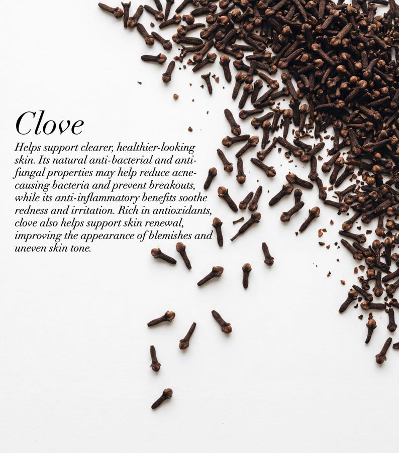 May include: A top-down shot of whole cloves scattered on a white surface. The image includes the word "Clove" in a stylized font, along with text describing the benefits of cloves for skin health.