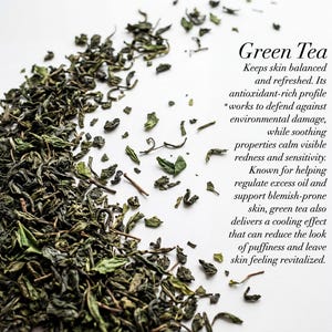 May include: A close-up of dried green tea leaves scattered on a white surface. The text "Green Tea" is displayed, along with a description of its benefits for skin health. The leaves are various shades of green.