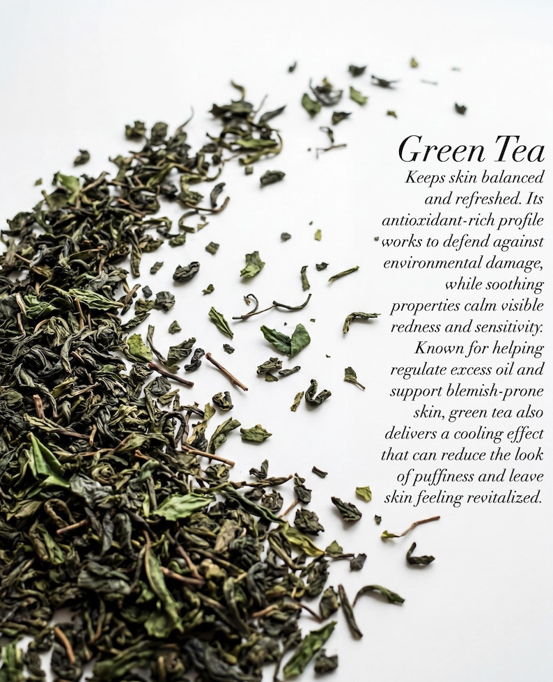 May include: A close-up of dried green tea leaves scattered on a white surface. The text "Green Tea" is displayed, along with a description of its benefits for skin health. The leaves are various shades of green.