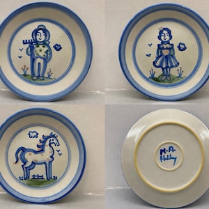 May include: A set of three ceramic plates with blue hand-painted designs featuring a person with a rake, a person in a dress, and a horse, plus one plate showing the underside with the blue hand-painted signature M.A. Hadley in the center.
