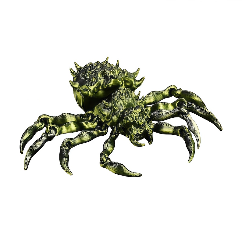 A metallic yellow‑green 3D printed spider with long curved legs and a spiky armored back is shown isolated on a pure white background.