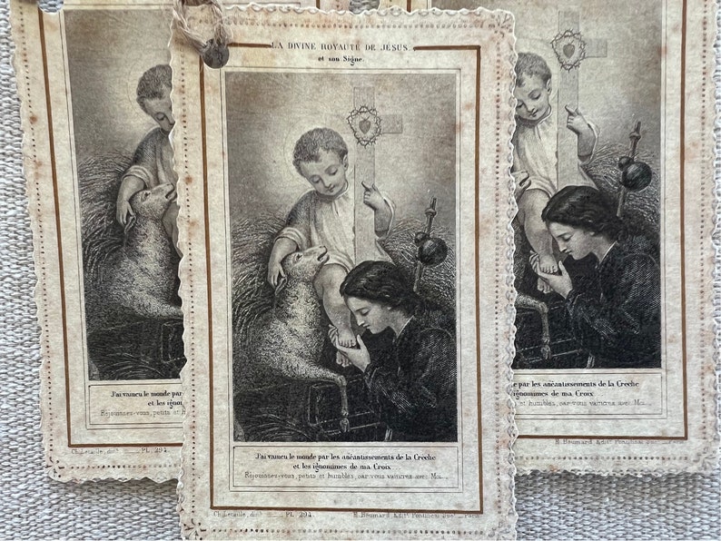 May include: A vintage religious card with a black and white illustration of a young boy with a lamb. The text on the card reads "J'ai rachet&eacute; le monde par les att de la Greche".
