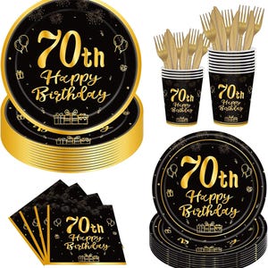 May include: A 70th birthday party supply set featuring black and gold paper plates, napkins, and cups with gold foil text reading 70th Happy Birthday. The set includes gold plastic forks and knives, all decorated with fireworks and gift box icons.