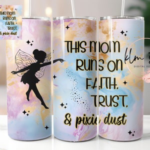 May include: Two stainless steel tumblers with a pastel blue, pink, and gold marble design. The tumblers feature a black silhouette of a fairy with wings and the text "This Mom Runs on Faith, Trust, & Pixie Dust".