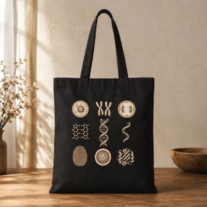 May include: A black tote bag featuring a grid of nine beige scientific illustrations, including a cell, chromosomes, a chemical structure, a DNA double helix, a single DNA strand, a fingerprint, a circular pattern, and a protein molecule.