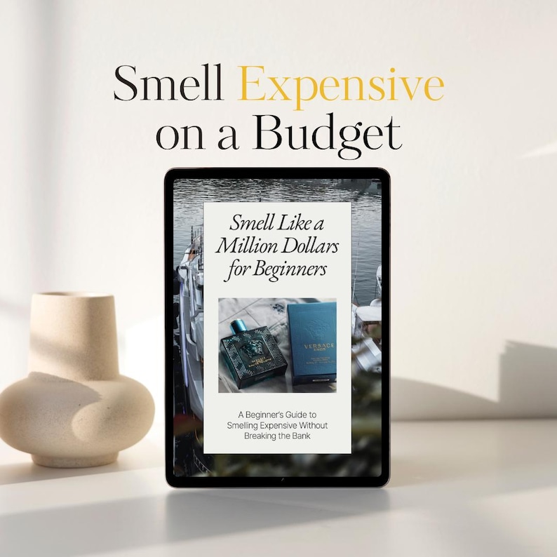 May include: A digital tablet displays a book cover with the title "Smell Like a Million Dollars for Beginners." The image also shows two perfume bottles and a decorative vase. The text "Smell Expensive on a Budget" is at the top.
