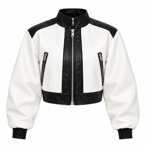 May include: A cropped jacket featuring a colour-blocked design in black and white. The garment has a high collar, a central silver-toned zip, and two slanted zipped pockets on the front. The sleeves are long with black ribbed cuffs.