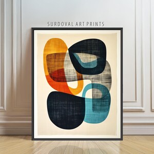 May include: Abstract art print featuring overlapping organic shapes in shades of orange, blue, and black. The artwork is framed in a black border and includes the text "SURDOVAL ART PRINTS" at the top. The shapes have a textured appearance.