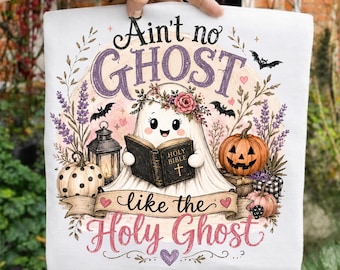 May include: A white t-shirt featuring a graphic of a cartoon ghost wearing a flower crown and reading a book labeled Holy Bible. The design includes pumpkins, a lantern, bats, and lavender sprigs with the text Ain't no GHOST like the Holy Ghost.