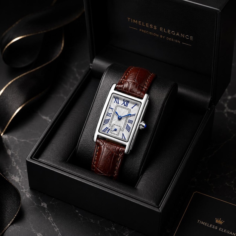 May include: A rectangular wristwatch with a silver-tone case, a white dial featuring blue Roman numerals, and a brown crocodile-embossed leather strap. The watch is presented in a black box labeled "TIMELESS ELEGANCE PRECISION BY DESIGN."