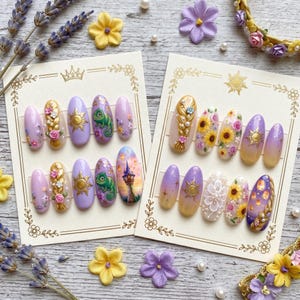 May include: Two sets of artificial nails with detailed designs. One set features a gold braid, flowers, and a sun emblem on a lilac base. The other set includes sunflowers, a white floral design, and a lantern scene on a gradient base.