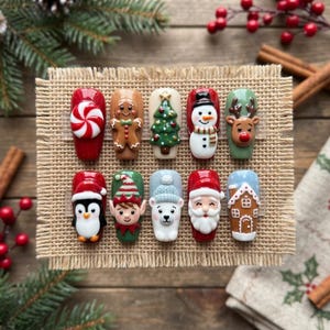 May include: A set of ten press-on nails featuring 3D Christmas designs including a peppermint candy, gingerbread person, pine tree, snowman, reindeer, penguin, elf, polar bear, Santa Claus, and a gingerbread house on a burlap display board.