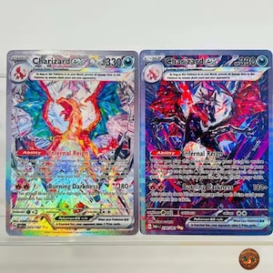 May include: Two Charizard ex trading cards with 330 HP, featuring the Infernal Reign ability and Burning Darkness attack. The left card displays a bright orange dragon, while the right card shows a dark, shadowy version, both with holographic foil.