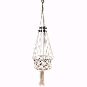 Peut inclure: Un porte-plante en macramé suspendu, fabriqué en corde de couleur naturelle. Il présente un panier tissé orné de perles noires en haut et autour du panier. Une gland pend en bas. Idéal pour les petites plantes en pot.