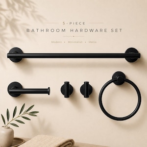 May include: A 5-piece bathroom hardware set in matte black, featuring a long towel bar, a toilet paper holder, two wall hooks, and a circular towel ring. The text 5-PIECE BATHROOM HARDWARE SET is displayed above the items in a clean font.