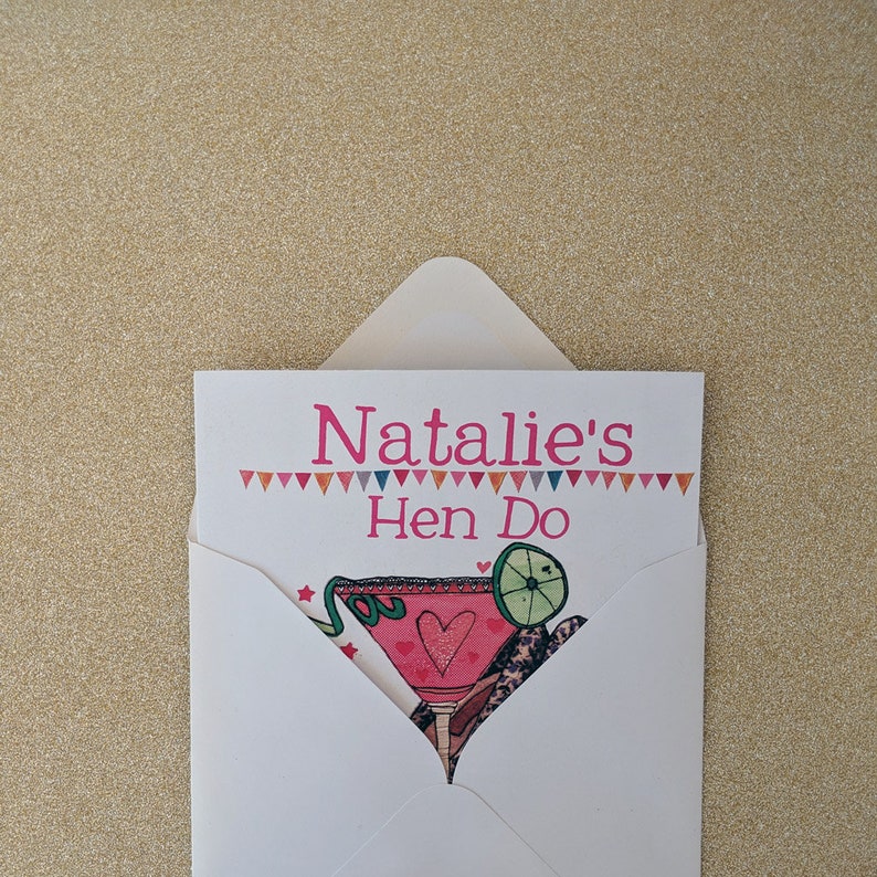 May include: A white envelope with a pink and blue card inside. The card has the text "Natalie's Hen Do" and a colorful illustration of a cocktail glass with a lime wedge.