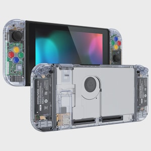 May include: A handheld video game console featuring a transparent clear plastic shell that reveals internal components, including a cooling fan, battery, and circuit boards. The device has colorful action buttons and a black screen display.