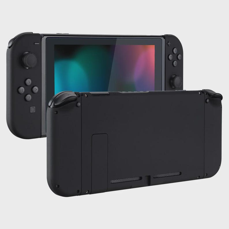 May include: A black handheld gaming console featuring a central screen with a colorful display and detachable controllers on each side. The device is shown from two angles, displaying the front screen and the solid black back panel with vents.