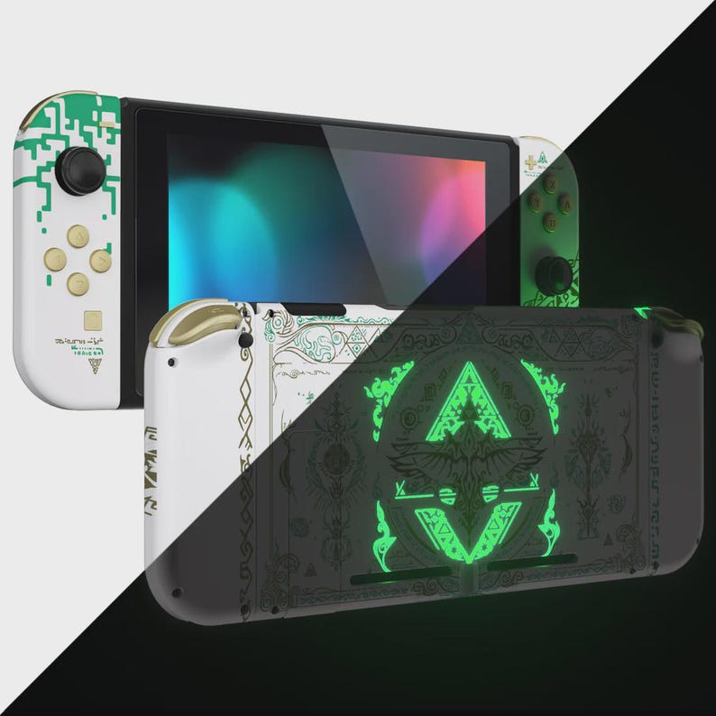 May include: A handheld gaming console featuring white and green digital circuit patterns on the controllers and a black back panel adorned with intricate, glowing green geometric symbols and ornate line art designs across the surface.