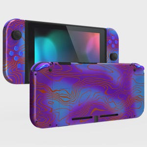 May include: A handheld video game console featuring a vibrant purple and blue gradient finish with an overlaid orange topographic line pattern. The device includes two detachable controllers on the sides and a central screen with a dark display.