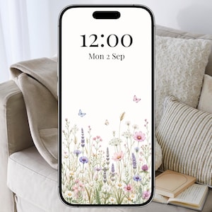 May include: A smartphone displaying a digital wallpaper with a white background featuring a watercolour illustration of wildflowers, grasses, and small butterflies at the bottom. The screen shows the time 12:00 and the date Mon 2 Sep in black text.