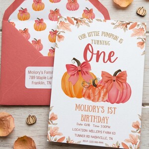 May include: A birthday invitation with a pumpkin theme. The invitation features three pumpkins with bows, the text "Our Little Pumpkin is Turning One," and event details. An envelope with pumpkin pattern is also visible.