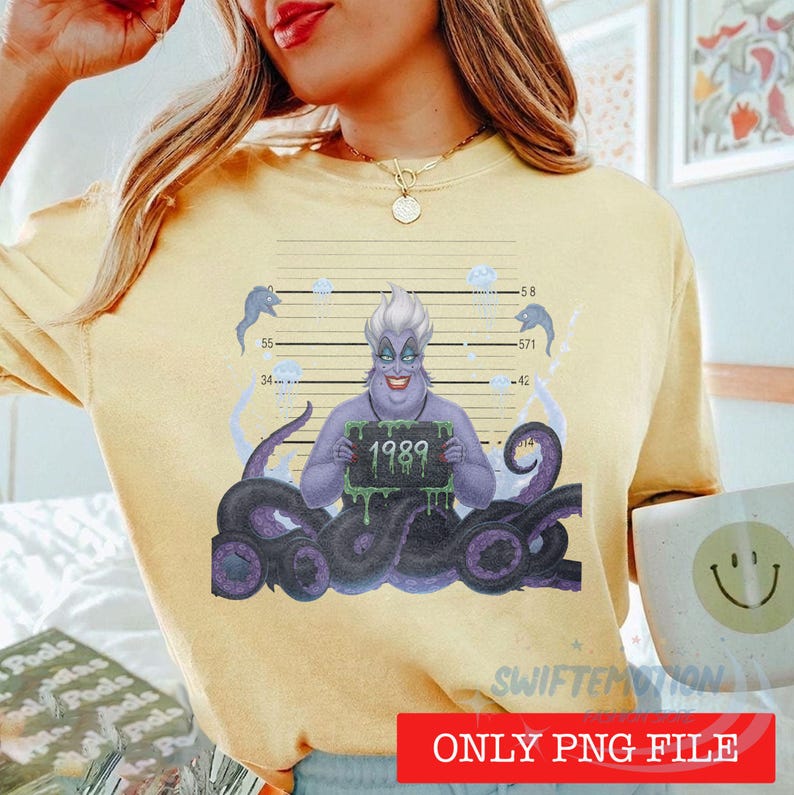 May include: A pale yellow t-shirt featuring a graphic of a purple sea witch with tentacles holding a mugshot sign that reads 1989. The design includes a height chart background with numbers and small jellyfish illustrations in blue and white.
