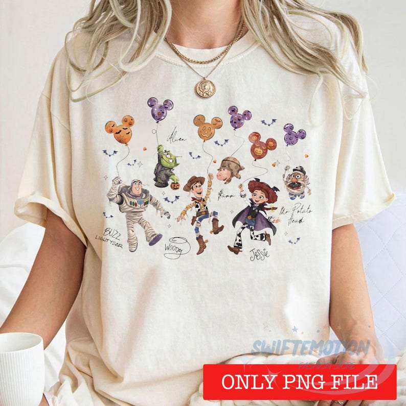 May include: A cream-colored t-shirt featuring a graphic print of Toy Story characters including Buzz Lightyear, Woody, Jessie, and Mr. Potato Head. The characters are holding Mickey-shaped balloons with Halloween motifs, accompanied by handwritten names.