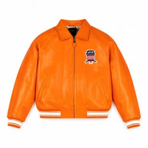 May include: A bright orange leather jacket featuring a full-length front zipper, a classic collar, and ribbed cuffs and hem with white stripes. On the left chest, there is a patch displaying the text AVIREX with a shield and American flag.