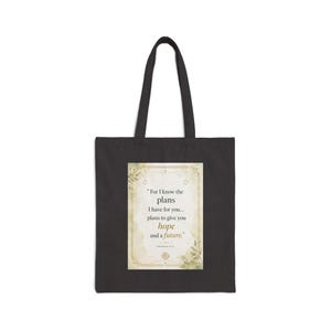 May include: Black tote bag with a rectangular design featuring the text "For I know the plans I have for you... plans to give you hope and a future." The design has a gold border and floral accents.