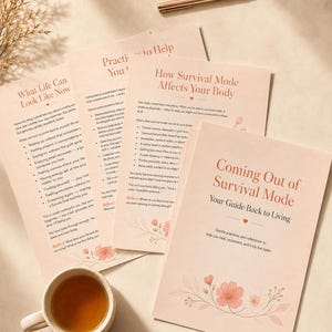 May include: A set of pale pink informational sheets titled Coming Out of Survival Mode, How Survival Mode Affects Your Body, and What Life Can Look Like Now, featuring floral illustrations, accompanied by a ceramic mug of tea and a rose gold pen.