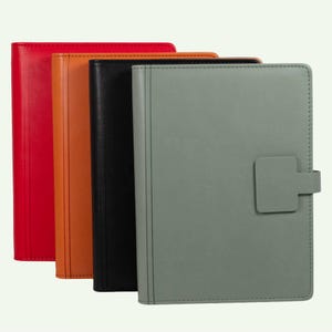 May include: A set of four rectangular notebooks with smooth covers in red, orange, black, and sage green. Each notebook features a vertical stitched spine detail and a matching rectangular tab closure on the right side of the front cover.