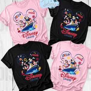 May include: Four short-sleeved t-shirts in light pink and black featuring a graphic of Disney characters on a cruise ship. The design includes the text 2026, Name, and Disney Cruise inside a Mickey Mouse ear outline with nautical icons like anchors.