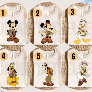 May include: Six off-white t-shirts featuring Disney characters in safari gear. Number 1 shows Mickey Mouse, 2 shows Minnie Mouse, 3 shows Donald Duck, 4 shows Pluto, 5 shows Goofy, and 6 shows Daisy Duck. Each character wears a hat and vest.