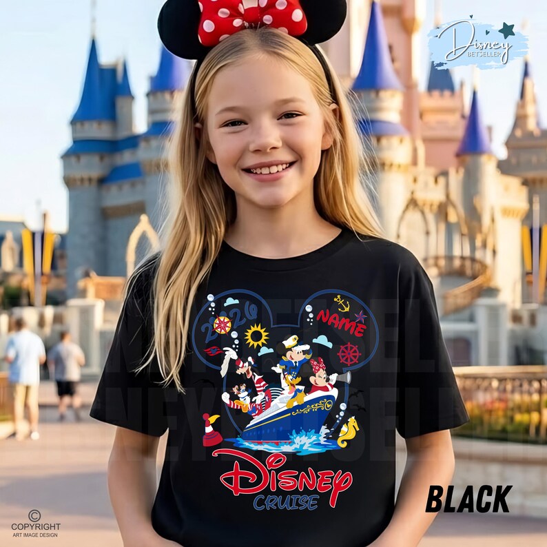 May include: A black t-shirt featuring a graphic of cartoon characters on a cruise ship inside a Mickey Mouse ear outline. The design includes the text 2026, NAME, and Disney Cruise, along with nautical icons like an anchor, ship wheel, and sun.