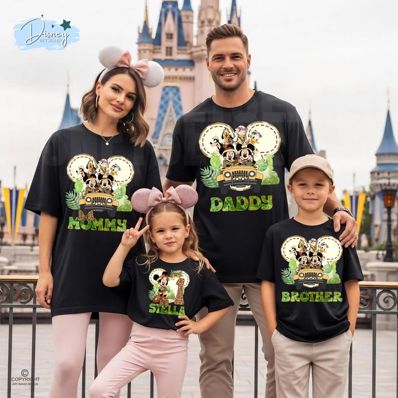 May include: Black family t-shirts with a Mickey Mouse safari design. The shirts feature the words "Mommy", "Daddy", "Stella", and "Brother". The family is posing in front of a castle.